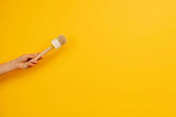 Woman Hand Holding Wooden Paint Brush Yellow Background Copy Space — Stock fotografie
