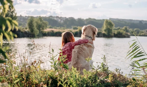 Child Girl Sitting Hugging Golden Retriever Dog Outdoors Nature Looking — Photo