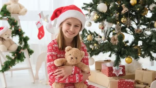 Pretty Child Girl Hugging Teddy Bear Christmas Tree Wearing Red — Wideo stockowe