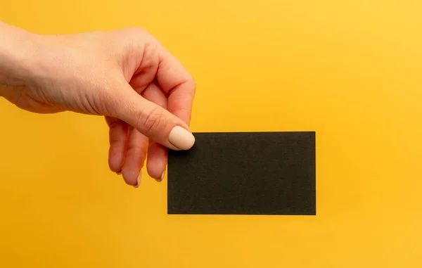 Black Business Card Copy Space Female Hand Yellow Background Mockup — Stock Photo, Image