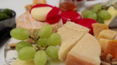 Peyniri üzümle karıştır, fındık ve zeytin bir masada, peynir tabağında.