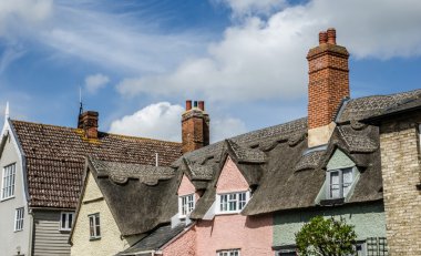 Roof tops with thatch and brick chimneys