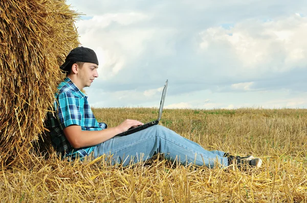 A business man in a countryside with a laptop — Stock Photo, Image