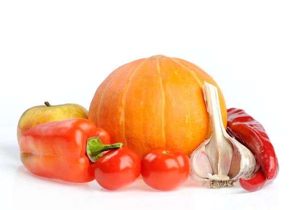 Studio shot of orange pumpkin with red peppers — Stock Photo, Image