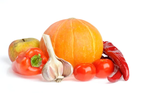 Studio shot of orange pumpkin with red peppers — Stock Photo, Image