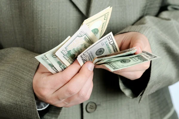 Businessman counts money in hands. — Stock Photo, Image