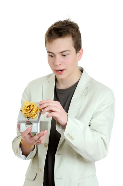 Surprised young man opening gift box over the white background — Stock Photo, Image