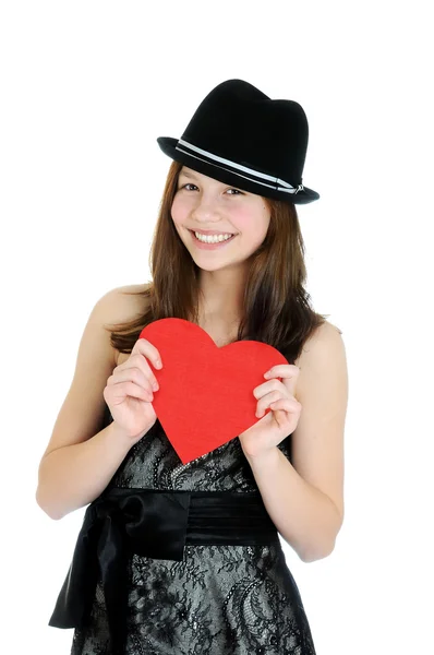 Smiling teenage girl holding valentine heart cut out from red pa — Stock Photo, Image