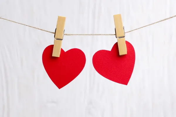 Red hearts hanging on wooden background — Stock Photo, Image