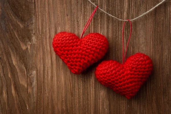 Two red heart hanging on wooden background — Stock Photo, Image