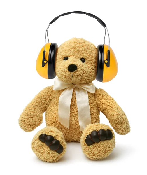 Teddy bear sitting with hear protectors — Stock Photo, Image