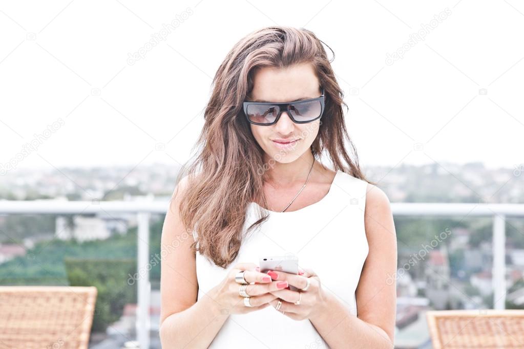 Attractive woman texting on her mobile