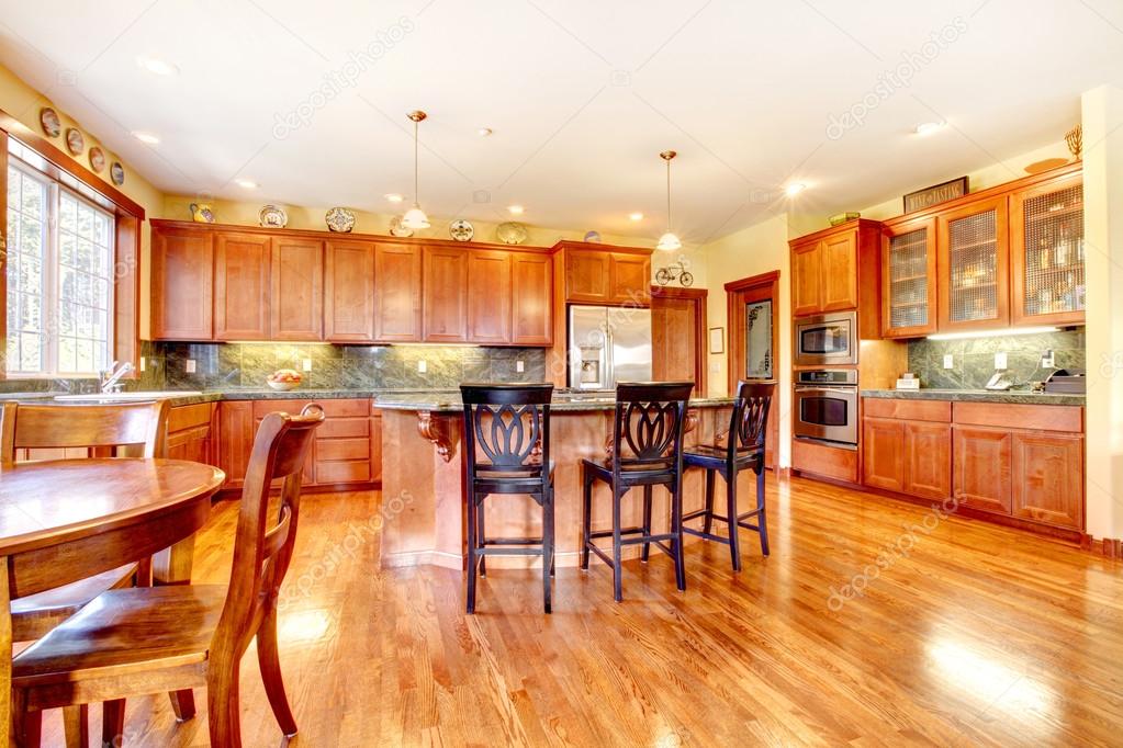 Luxury large cherry wood kitchen with green and yellow.