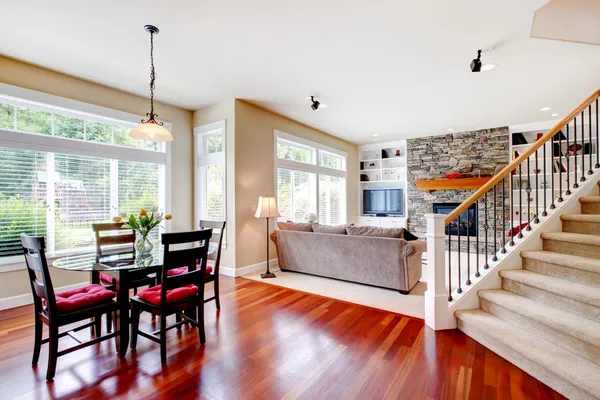 Large living and dining room with staircase, cherry hardwood. — Stock Photo, Image