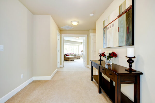 Large home hallway with art and furniture.