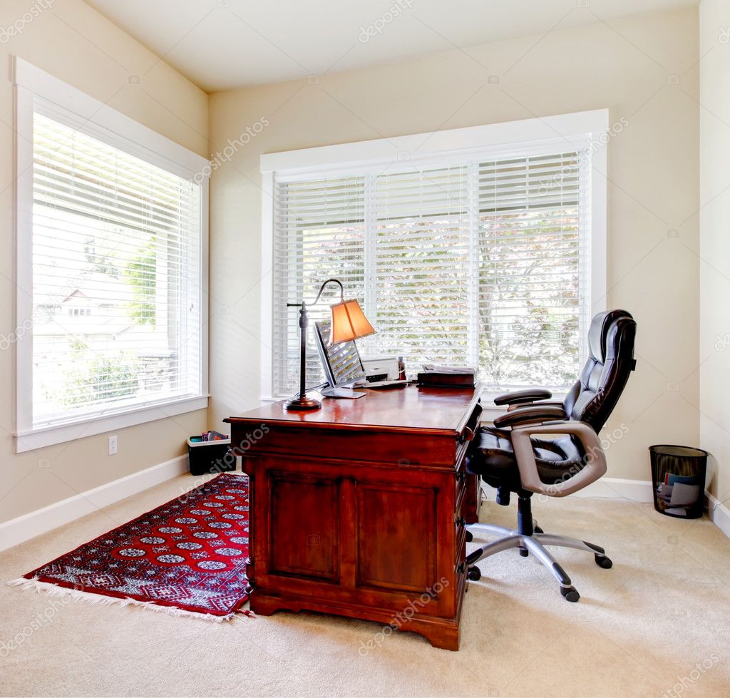 Home office with mahogany desk and letaher chair.