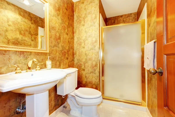 Golden antique bathroom with white toilet and sink. — Stock Photo, Image