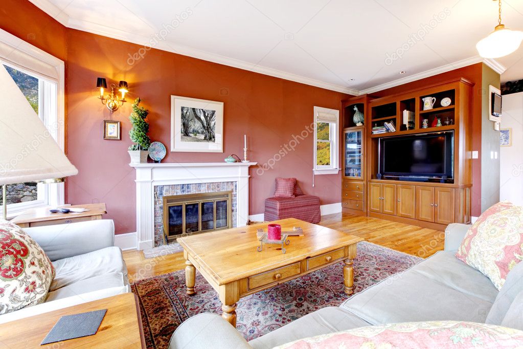 Large nice living room with red walls and fireplace.