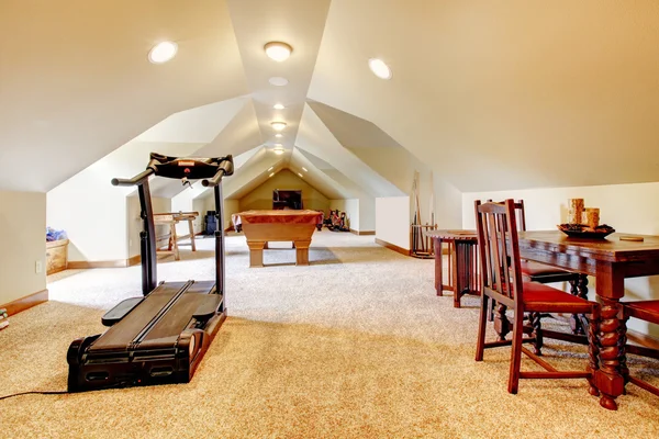 Large long attic game room with tv, pool and sport equipment. — Stock Photo, Image
