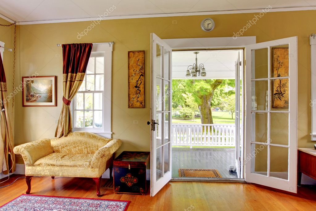Living room with open doors to the front porch. Romantic classic. Stock