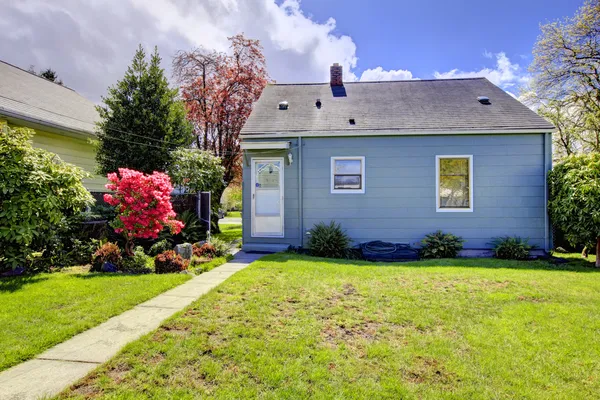 Blue small house with spring landscape from backyard. Stock Photo