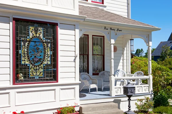 Historical white American house porch with stain glass window. — Stock Photo, Image