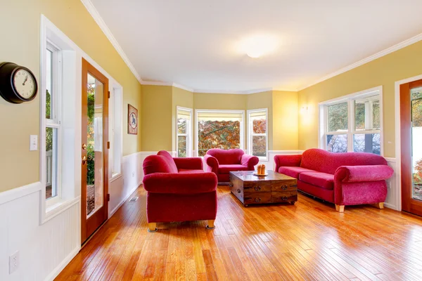 Farm house large dining room with red sofas and hardwood floor. — Stock Photo, Image