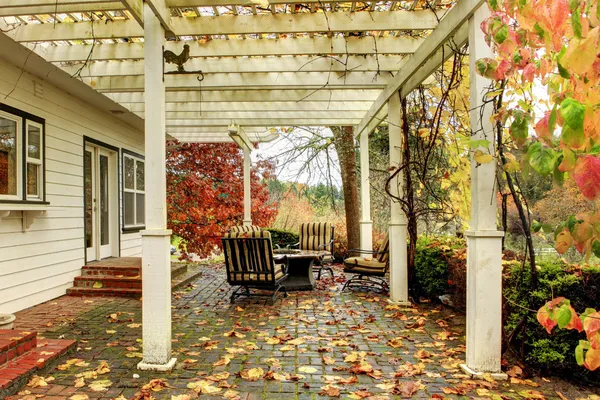 White farm American house during fall with green grass. Covered