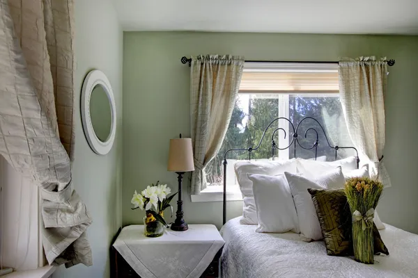 Olive tones bedroom with antique iron frame bed — Stock Photo, Image