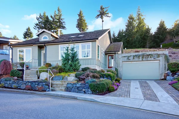 Northwest tile roof small house with a beautiful flowerbed — Stock Photo, Image