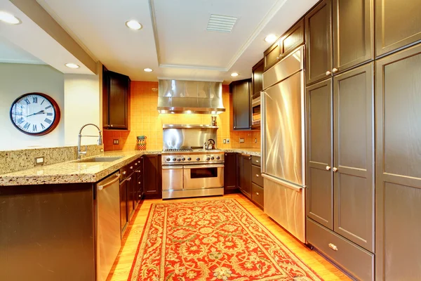 Shiny kitchen with black wood cabinets — Stock Photo, Image