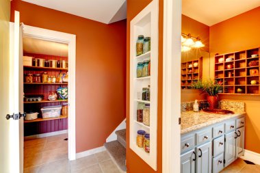 Rust and white small hallway with designed built-in shelves