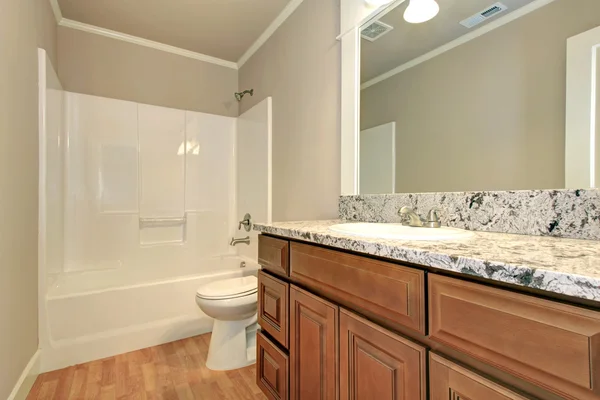 Empty bathroom with wooden storage — Stock Photo, Image