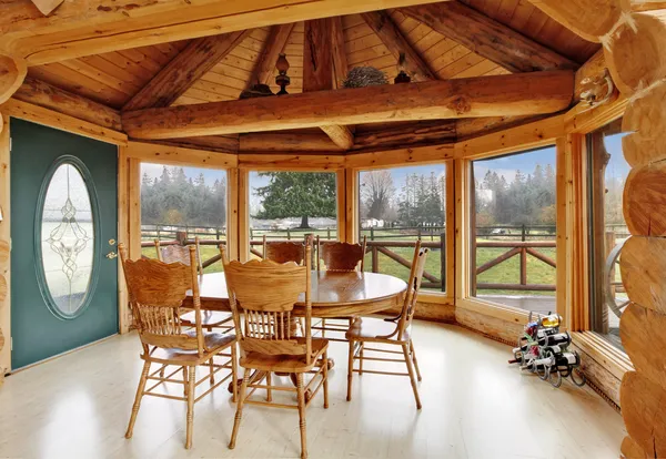 Beautiful dining room in log cabin house — Stock Photo, Image