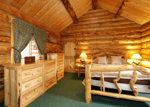 Cozy bedroom in log cabin house — Stock Photo, Image