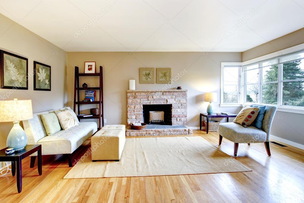 Light tones living room with a rocky background fireplace