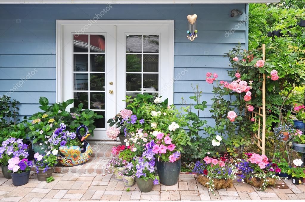 Exterior with french door decorated with flowers Stock Photo by ©iriana88w