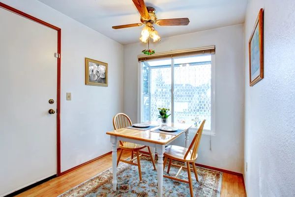 Small dining area with a rustic table set — Stock Photo, Image