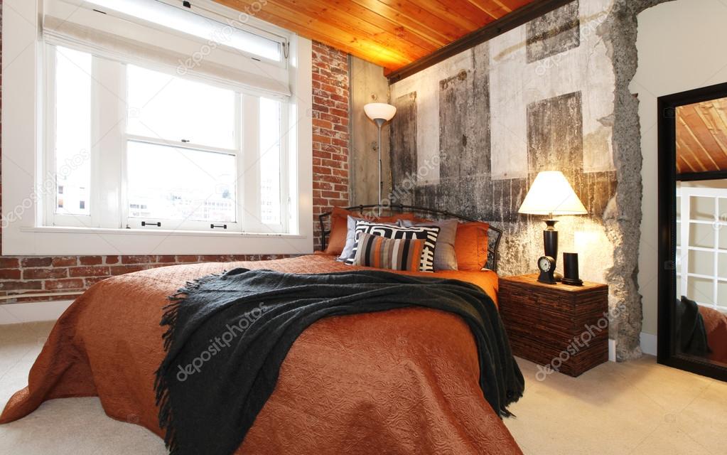 Modern bedroom with a broken concrete wall