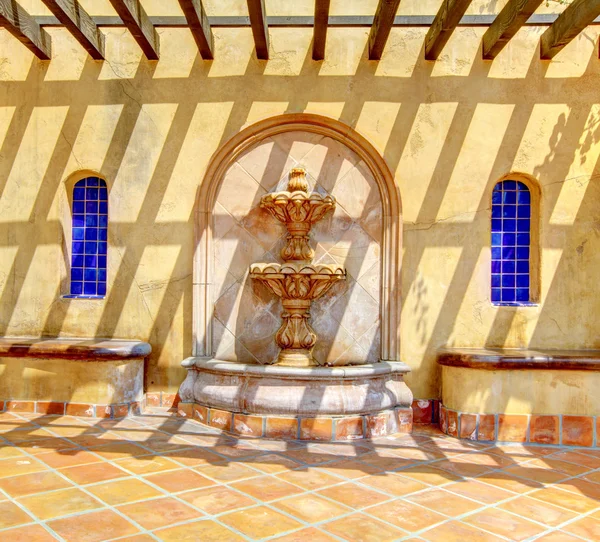 Spanish fountain detals with yellow wall. — Stock Photo, Image