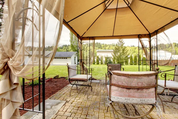 Backyard gazebo with antique chairs — Stock Photo, Image