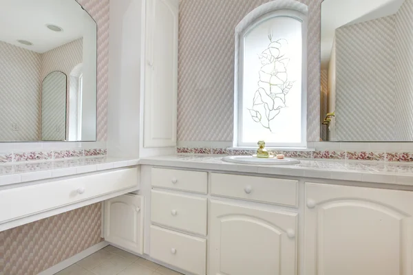 White vanity in soft pink bathroom — Stock Photo, Image