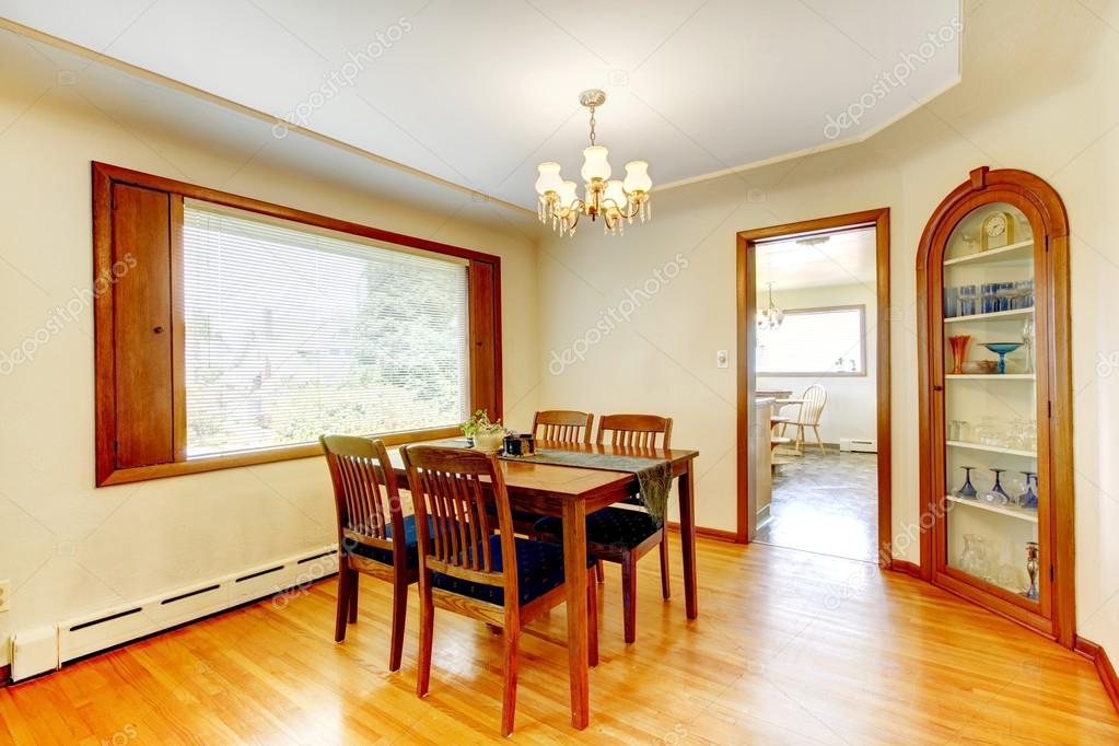 Soft tones dining room with wooden furniture