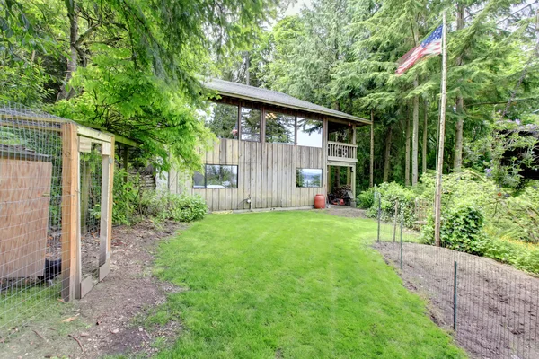 Wooden house with backyard — Stock Photo, Image