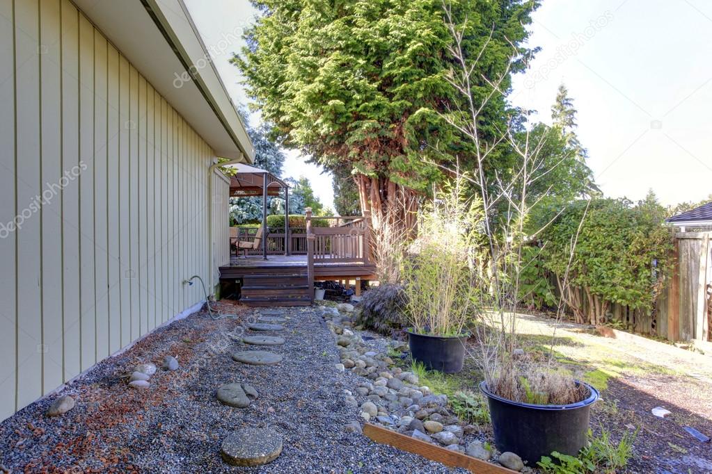 Backyard view. Gravel walkway to deck