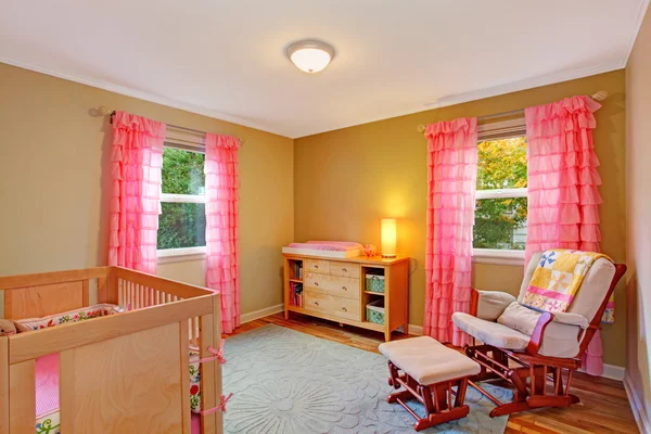 Nursery room with pink ruffle curtains — Stock Photo, Image