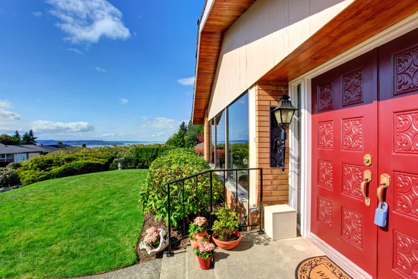 Modern house entrance porch with red door — Stock Photo, Image