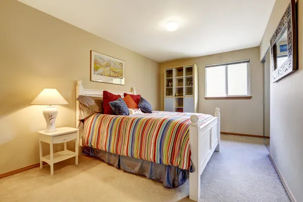 Cozy bedroom with white rustic bed — Stock Photo, Image