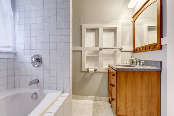 Bright empty bathroom interior with brown vanity cabinet — Stock Photo, Image