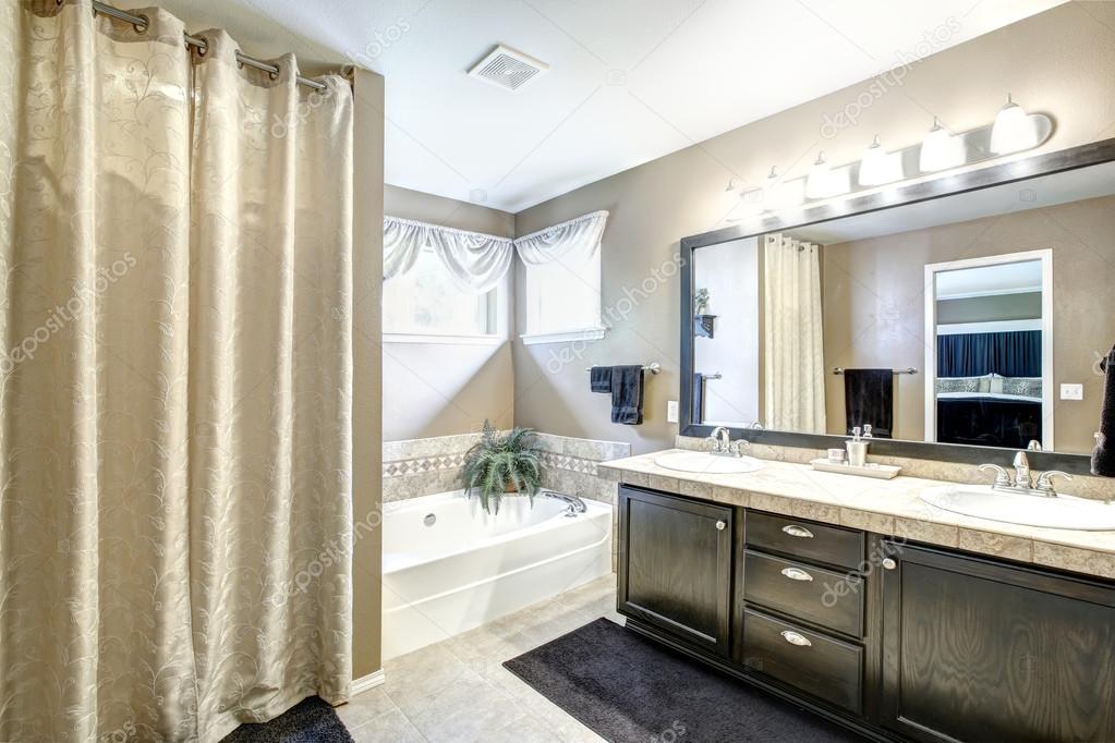 Bathroom interior with black cabinet and large mirror